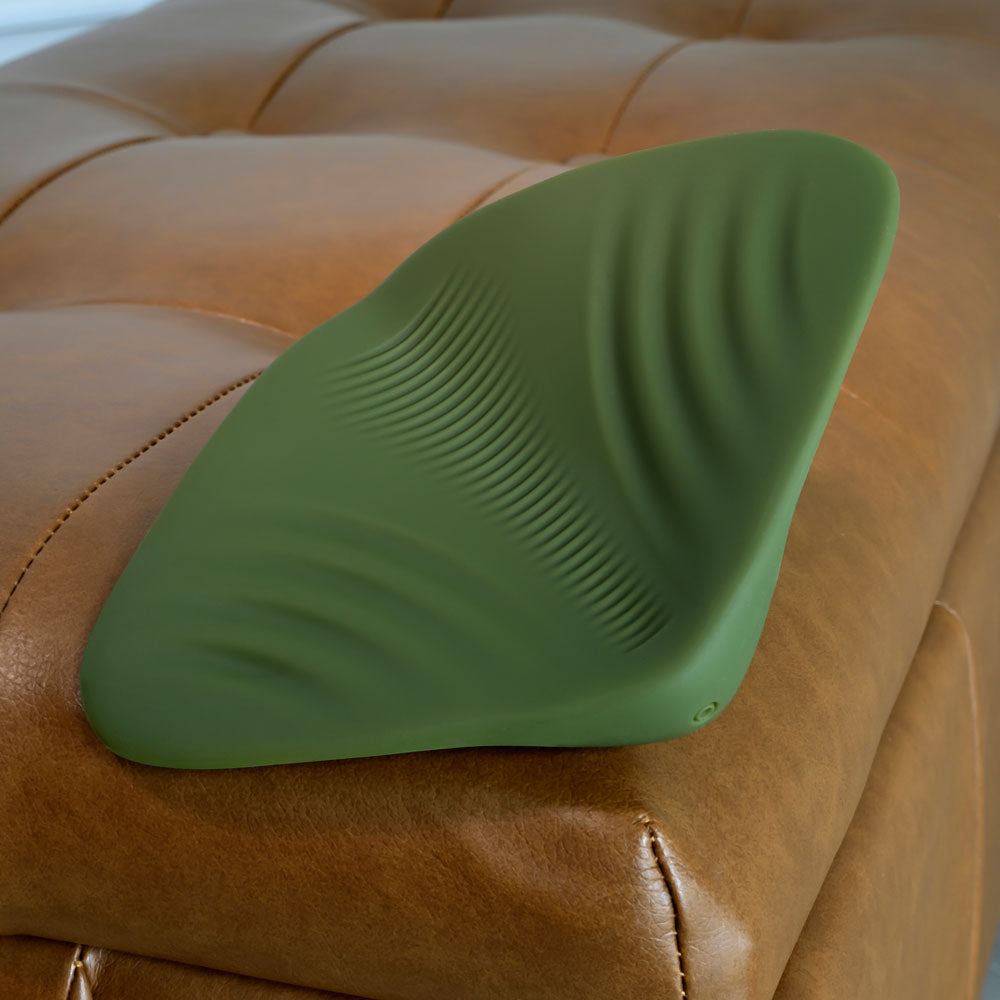 Gender X PLEASURE PAD -  USB Rechargeable Grinding Pad on a brown leather surface, showcasing soft silicone texture.