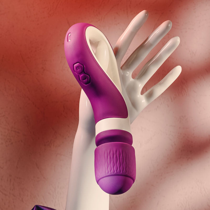 Gender X HANDLE IT - /White USB Rechargeable Massager Wand in a purple and white design, held by a mannequin hand.