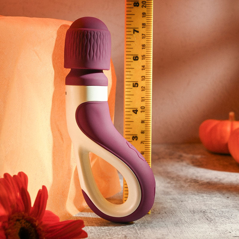 Gender X HANDLE IT - /White USB Rechargeable Massager Wand next to a ruler on a textured surface with flowers.