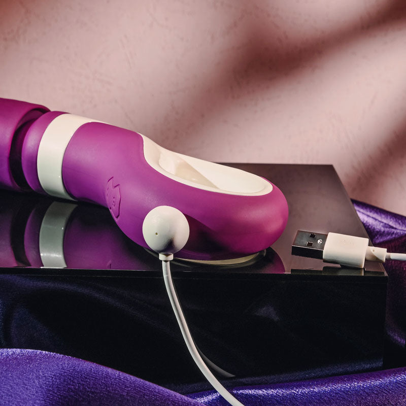 Gender X HANDLE IT - /White USB Rechargeable Massager Wand on a reflective surface with USB charging cable.
