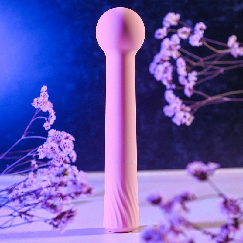 Gender X FLEXI WAND -  16.6 cm USB Rechargeable Vibrator against a backdrop of delicate flowers.