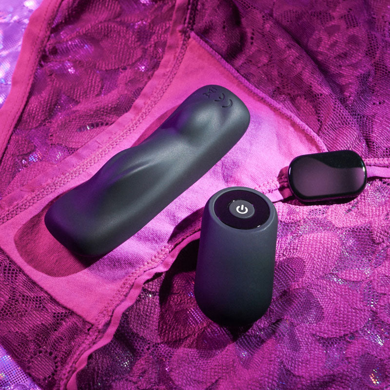 Gender X OUR UNDIE VIBE - USB Rechargeable Panty Vibe next to remote on lace underwear for intimate essentials for her.