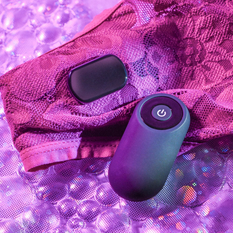 Gender X OUR UNDIE VIBE -  USB Rechargeable Panty Vibe with remote on lace fabric background.