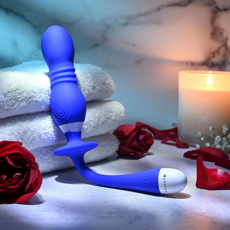 Rechargeable vibrating orbs placed beside soft towels and roses, lit by candlelight for a relaxing ambiance.