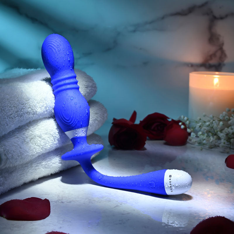 Gender X PLAY BALL - rechargeable vibrating orbs on a towel with candles and rose petals.