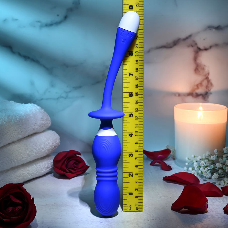 Gender X PLAY BALL - 25 cm USB Rechargeable Thrusting & Vibrating Orbs next to a ruler and candles with roses.