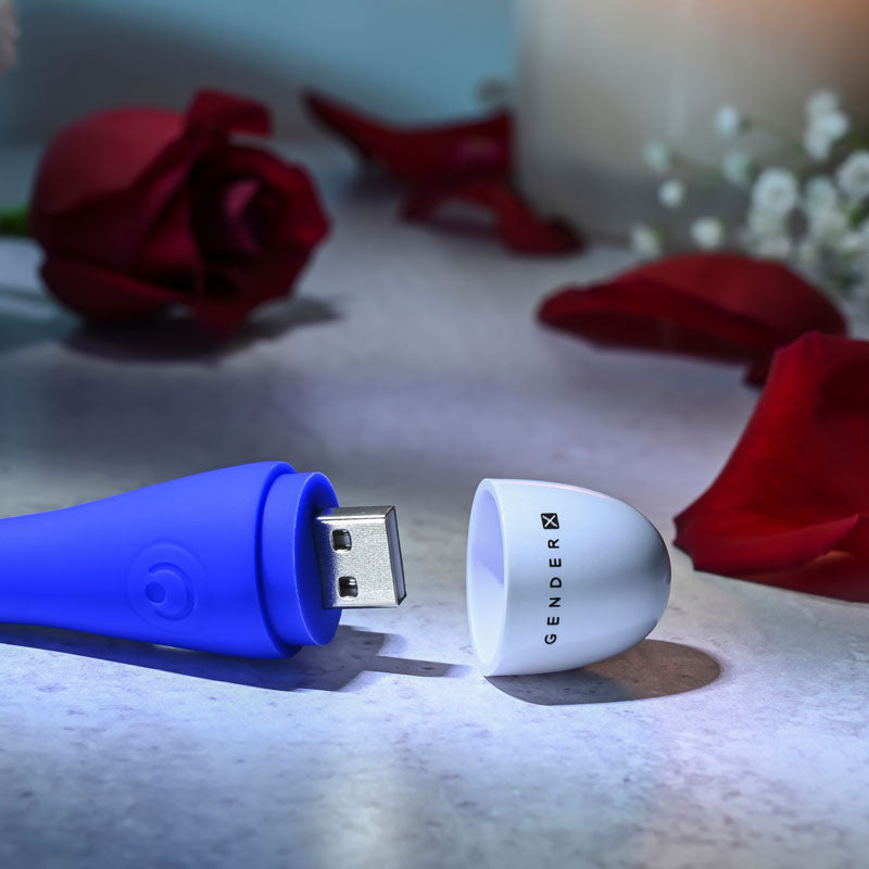 Gender X PLAY BALL - 25 cm USB Rechargeable Thrusting & Vibrating Orbs charging with rose petals in the background.
