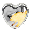 Edible Massage Candle - Tropical Pineapple Flavoured - 113 g in a heart-shaped tin with a person taking a bite of pineapple.