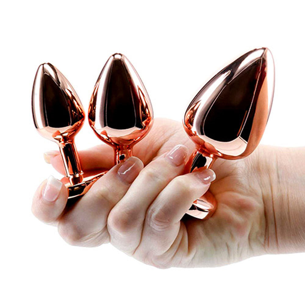 Adam & Eve HEART GEM ANAL TRAINING SET - Metal Anal Plugs with Pink Gem Bases - Set of 3 Sizes held in hand.