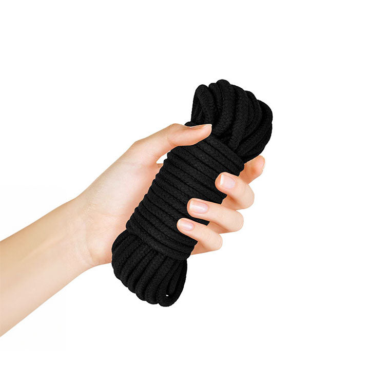 Hand holding the Adam & Eve Bondage Rope 9 metre for erotic control and restraint.