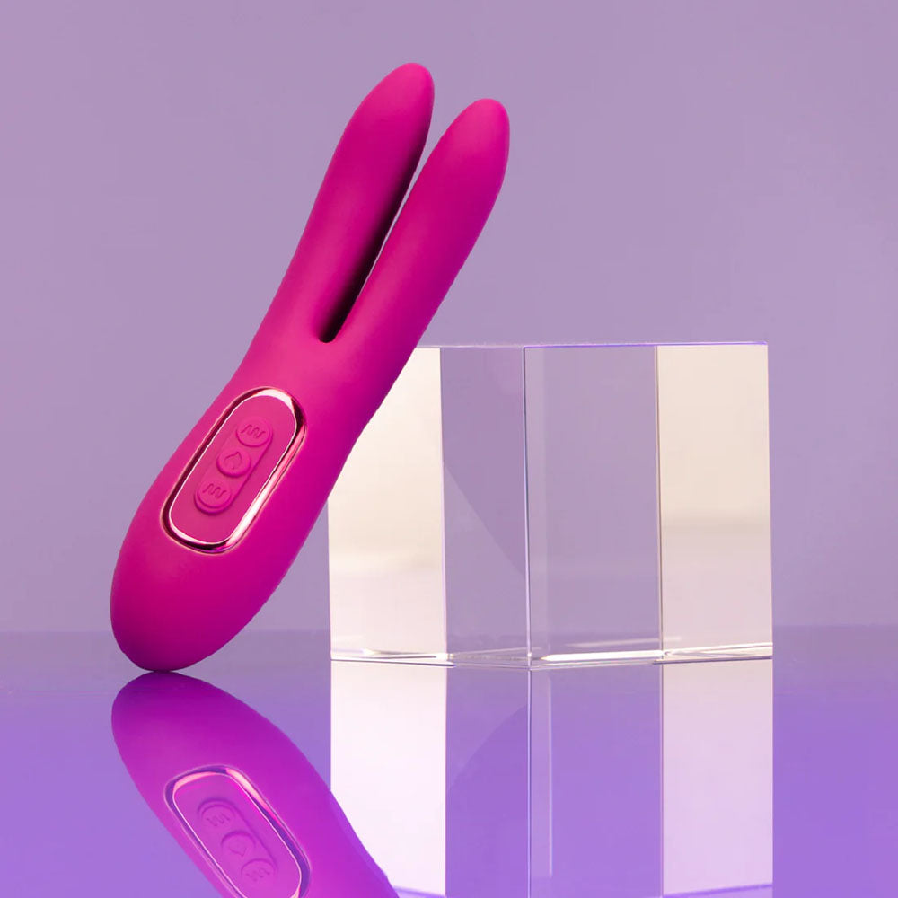 JimmyJane Solis Ascend 2 PRO - 16 cm USB Rechargeable Dual Tip Stimulator next to clear blocks on a purple background.
