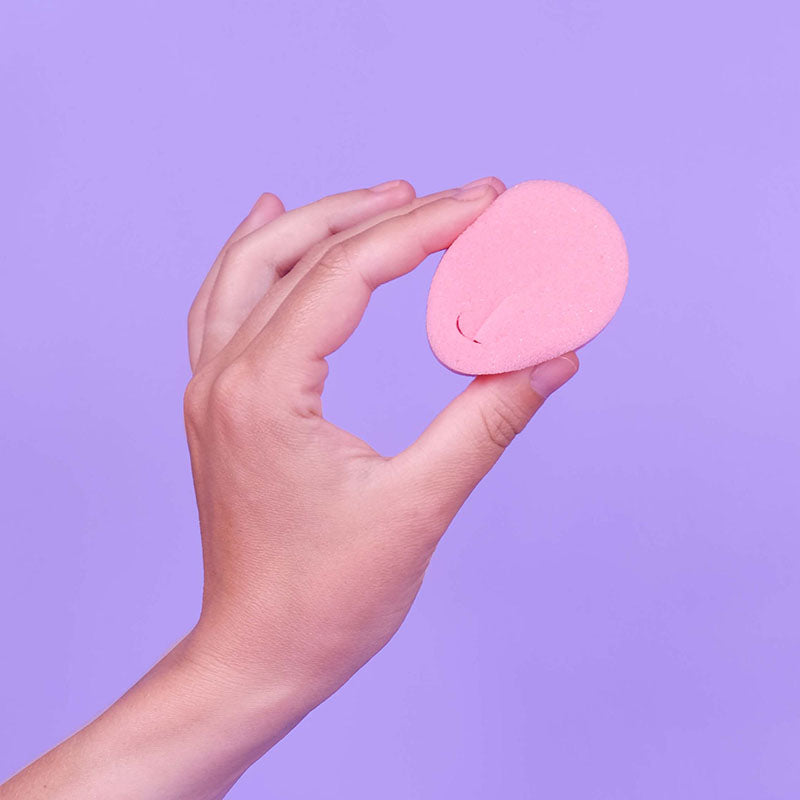Beppy Classic Sponge - Wet - Wet Feminine Sponge - Single Pack held in a hand against a purple background.