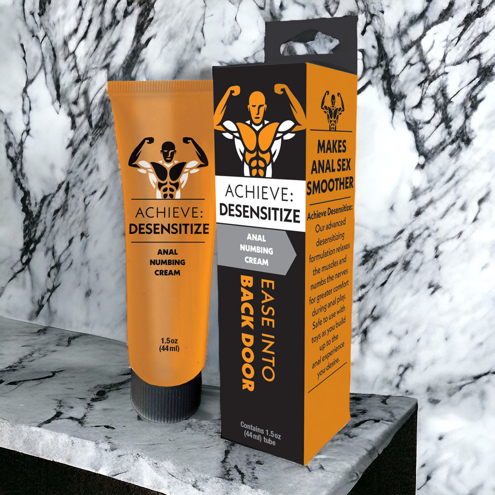 Achieve Desensitizing Cream 44 ml tube and packaging for anal desensitizing cream on marble surface.
