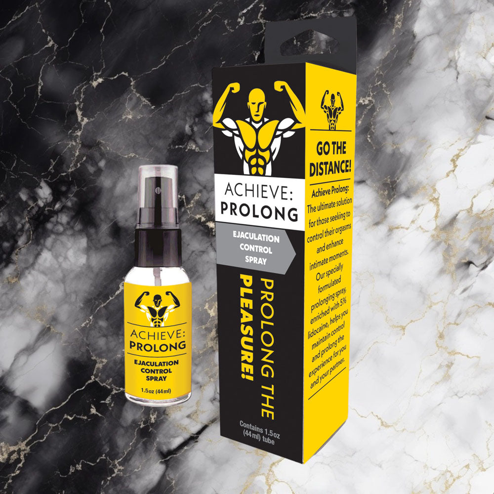 Achieve Prolong Ejaculation Control Spray for Men 1.5 oz bottle and packaging on a stylish black marble background.