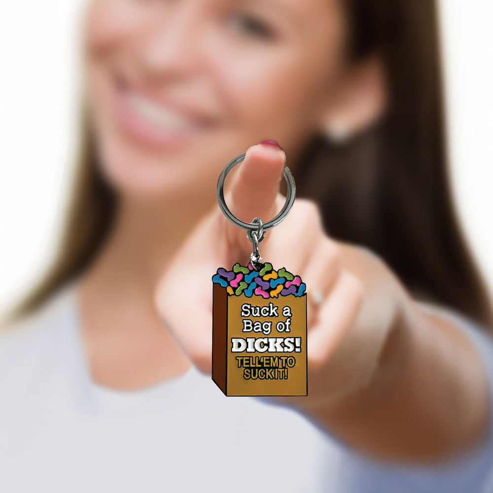 Super Fun Key Chain - Suck A Bag - Novelty Keychain held by smiling woman, showcasing colorful design with cheeky text.
