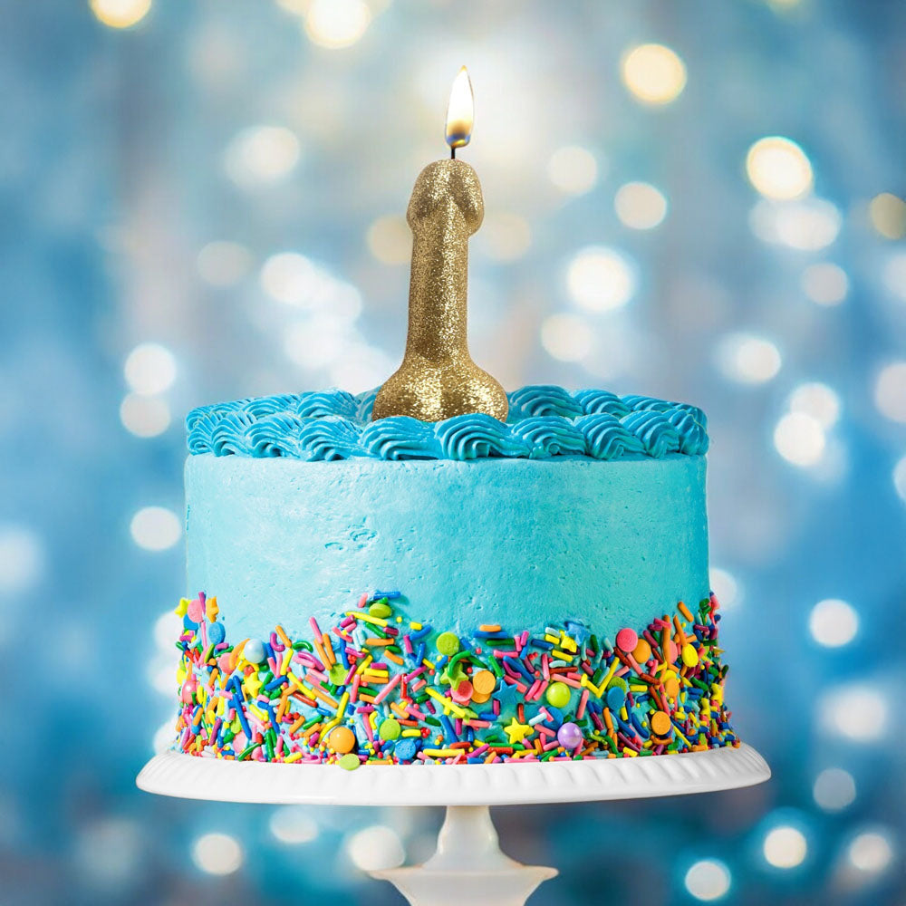 Glitterati Gold Glitter Penis Candle - Gold 10 cm Penis Party Candle on a blue celebratory cake with colorful sprinkles.