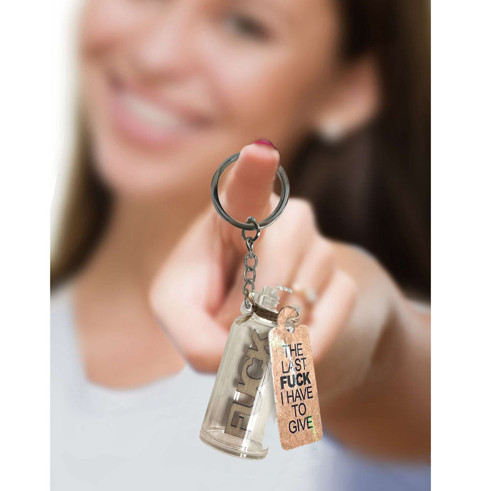 Novelty keychain last fuck I have to give showcased by a smiling woman holding it up.