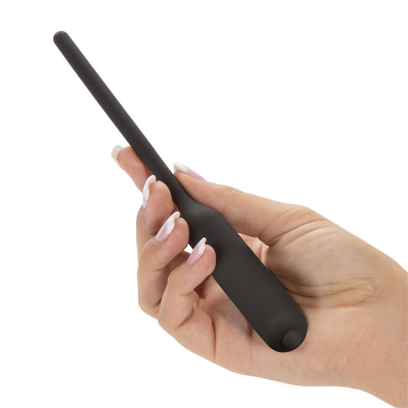 Ultimate Silicone Vibrating Urethral Dilator -  Vibrating Urethral Sound held in hand, showcasing its sleek design for intimate exploration.