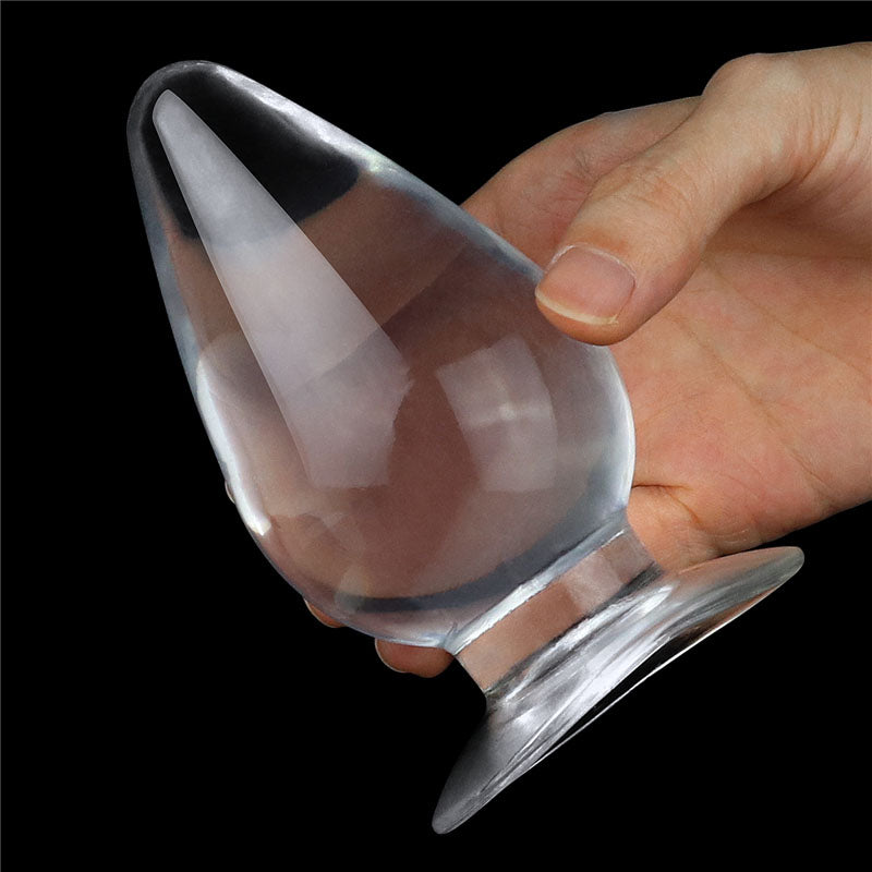 Flawless  Anal Plug 4.5'' -  11.5 cm Butt Plug held in hand, showcasing its clear design and ergonomic shape.