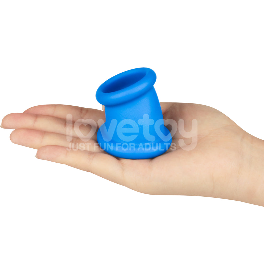 Pinnacle Pro Tapered Squeeze -  Ball Stretcher held in a hand, showcasing its blue silicone design for comfort and stimulation.