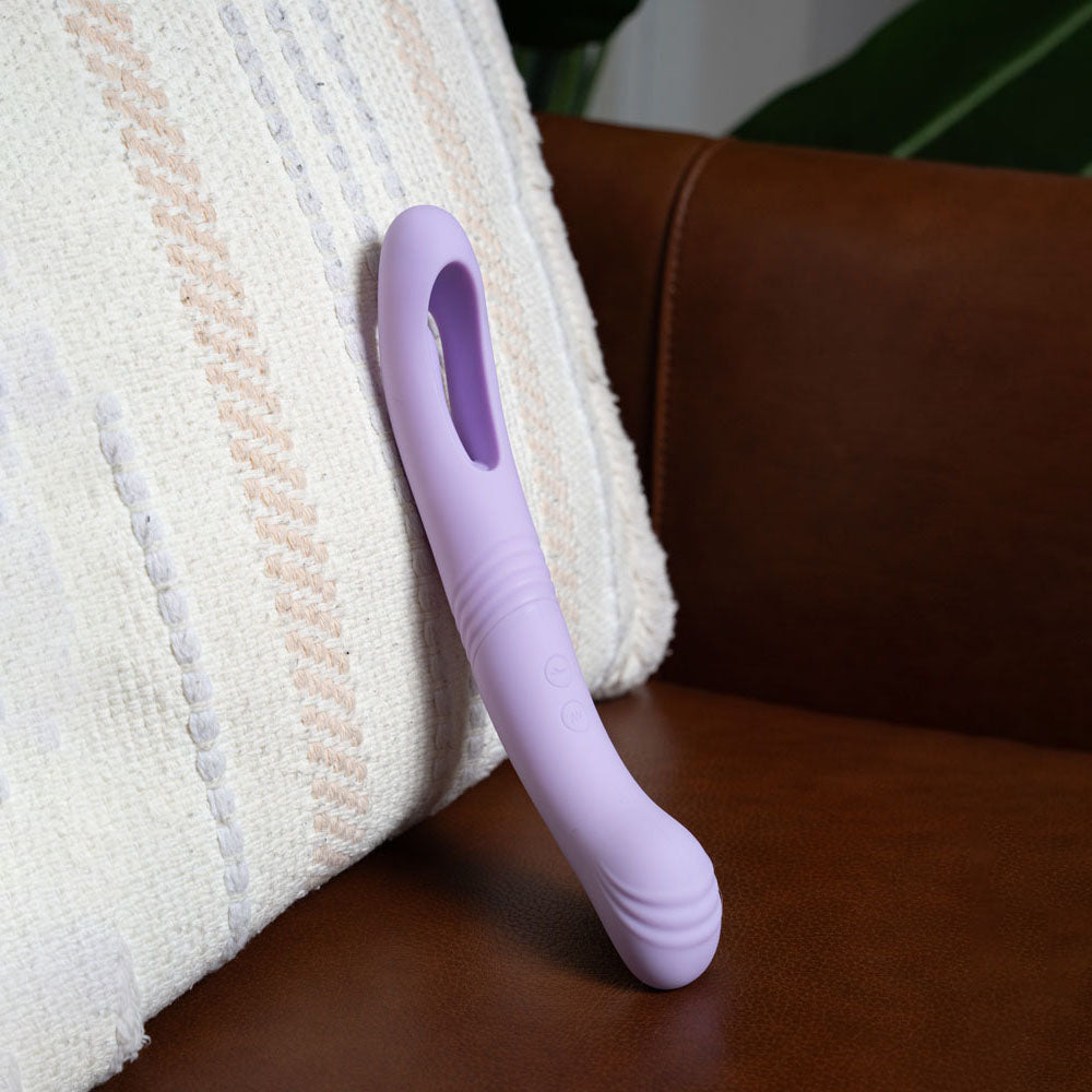 Maia HARPER - 24.1 cm USB Rechargeable Vibrator resting on a brown couch, showcasing its sleek design and texture.