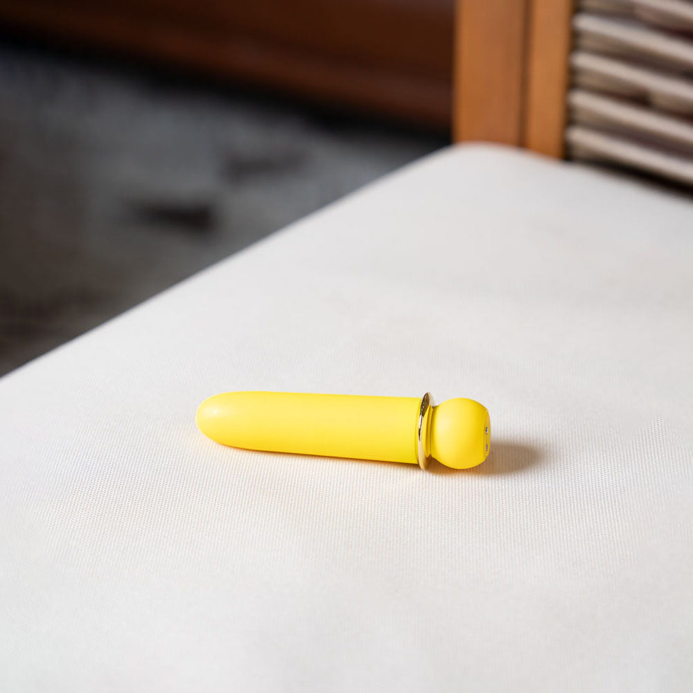 Maia JAGUAR -  -  10.1 cm USB Rechargeable Bullet in vibrant yellow color on a soft surface.