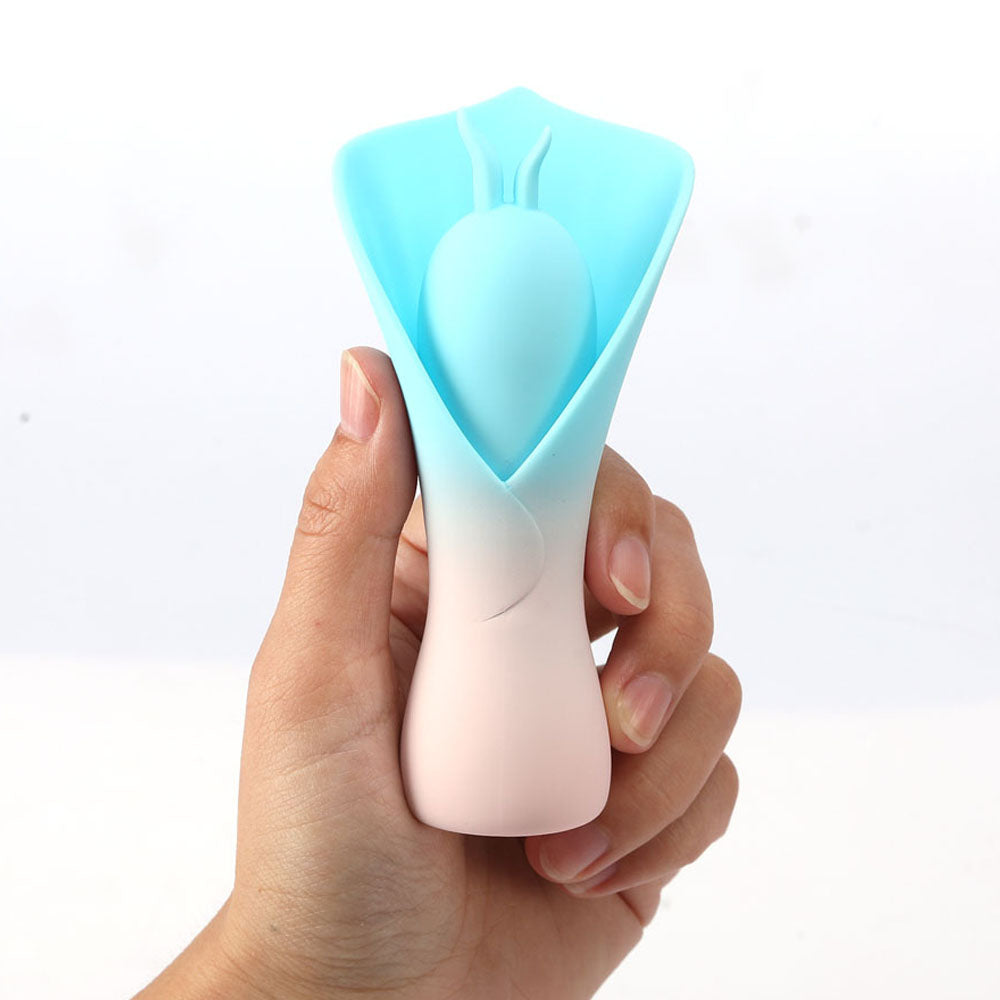 Maia MINA -  - /Pink USB Rechargeable Fluttering Flower Stimulator held in hand, showcasing its unique design and colors.