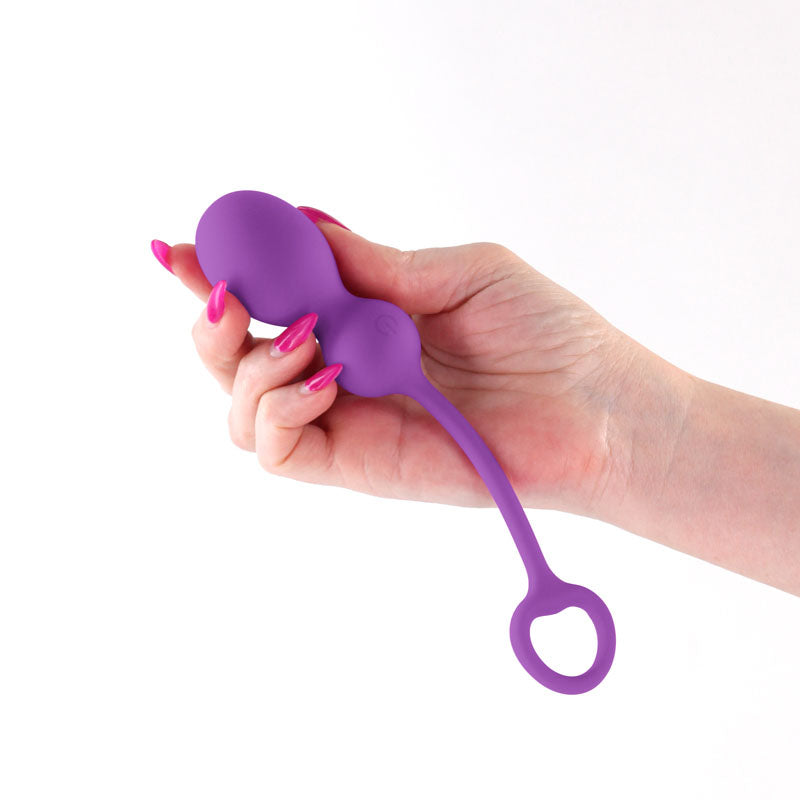 Techno - Bop -  USB Rechargeable Vibrating Kegel Exerciser with App Contol held in a hand, showcasing its sleek design and features.