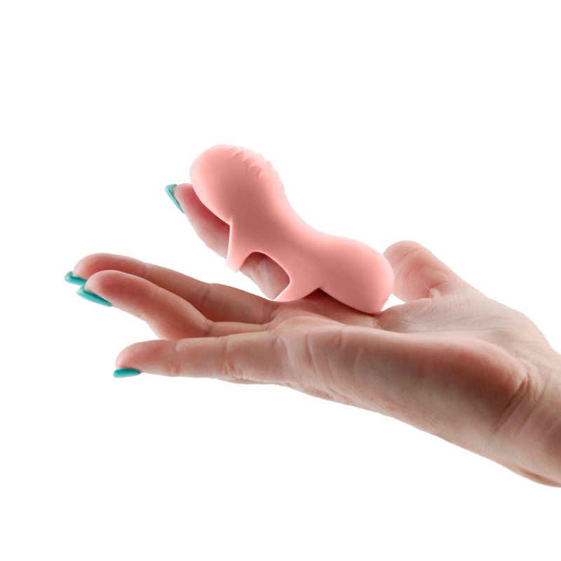 Desire - Fingerella -  -  USB Rechargeable Finger Stimulator held in a hand, showcasing its compact size and design.