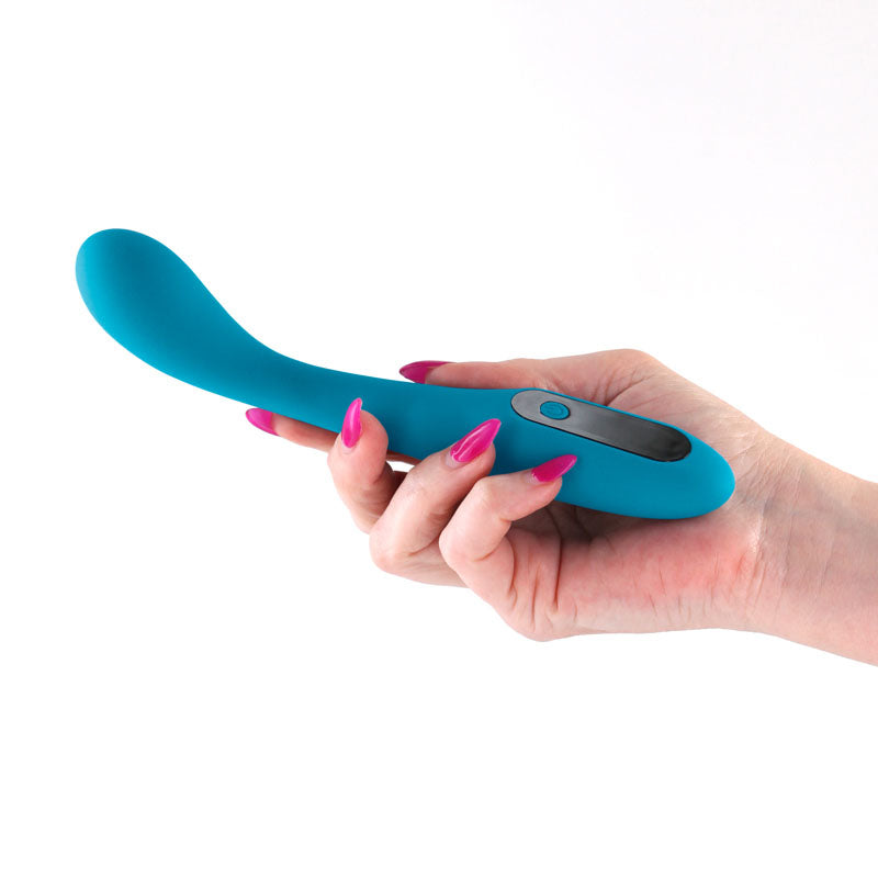 INYA Technica - Teal - Teal 19.2 cm USB Rechargeable Warming Vibrator held in hand with pink nails.