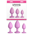 INYA Triple Ace Kit - Blush - Butt Plugs - Set of 3 Sizes displayed with textured designs and strong suction cups.