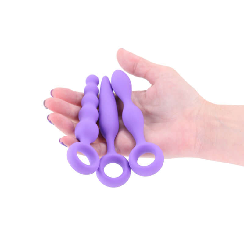 INYA Trio Kit - Set of 3 beginner anal plug set in purple silicone held in a hand for comfort and exploration.