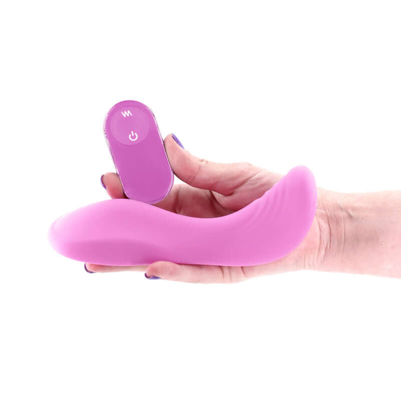 USB rechargeable vibrating grinder pad in hand with remote control, designed for pleasure and comfort.