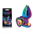 Rear Assets Multi  Heart - Multi  Medium Metal Butt Plug with Rainbow Heart Gem Base next to its packaging.