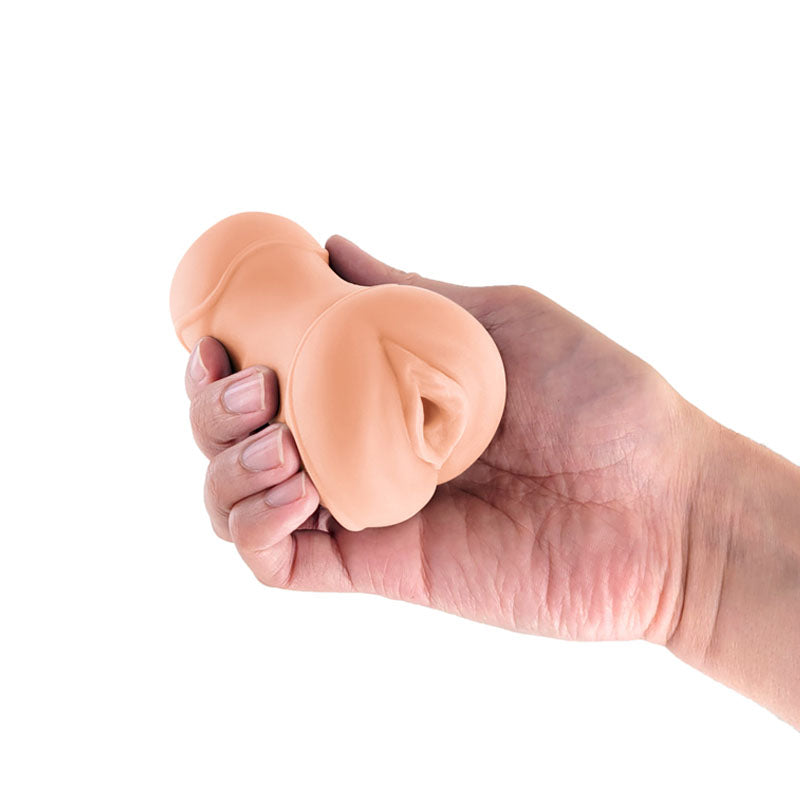 Pocket Pals Vagina Stroker - Tan - Tan Vagina Stroker in a hand, showcasing its realistic design and compact size.