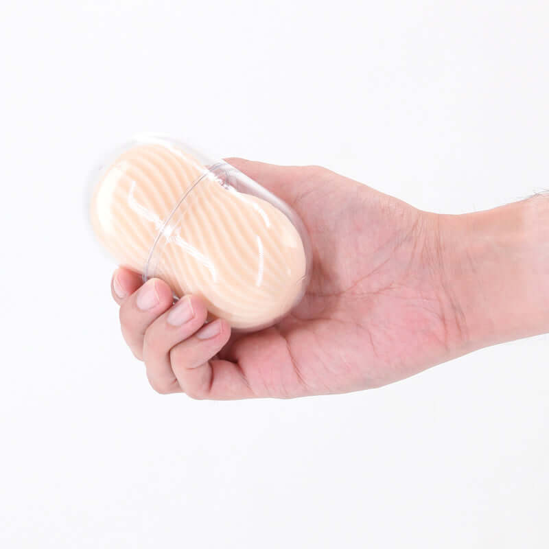 Hand holding Pocket Pals Misty travel mini stroker in a compact case for easy use and storage.