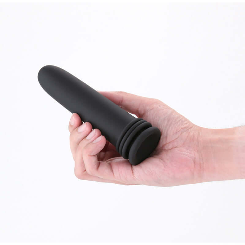 Person holding a black anal dilator from the anal dilator set for beginners, showcasing its sleek design.