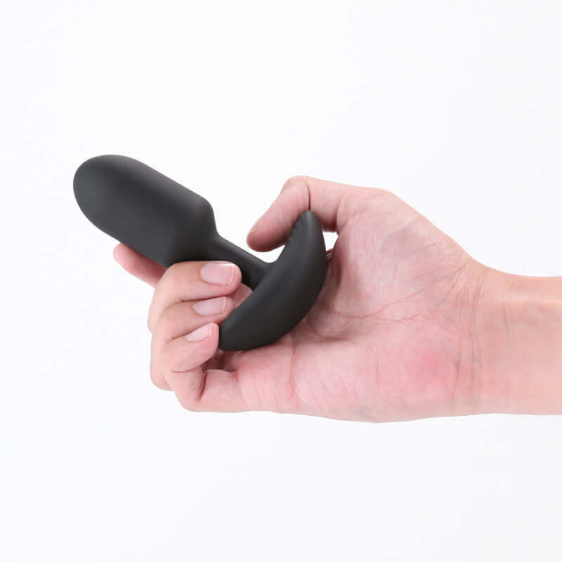 Hand holding the Renegade Pulse, a USB rechargeable vibrating butt plug, showcasing its sleek design and body-safe silicone.