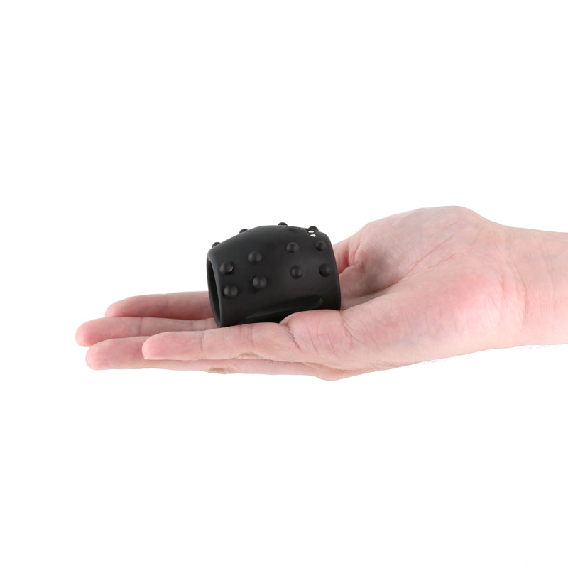Renegade Sidekick -  -  USB Rechargeable Vibrating Penis Cage held in hand, showcasing its unique design and body-safe silicone.