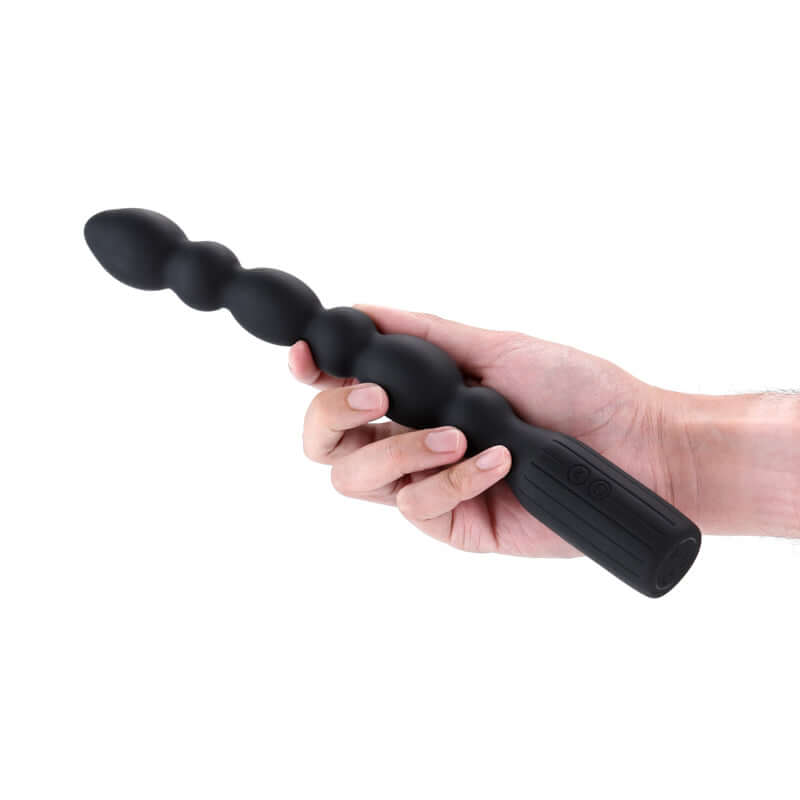 Renegade Prime USB rechargeable vibrating anal beads held in a hand, showcasing smooth silicone texture and design.