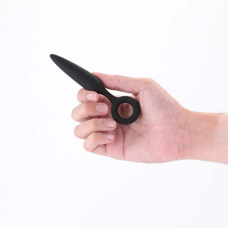 Hand holding Renegade Slide 12.7 cm anal plug, a beginner silicone anal plug designed for comfort and control.