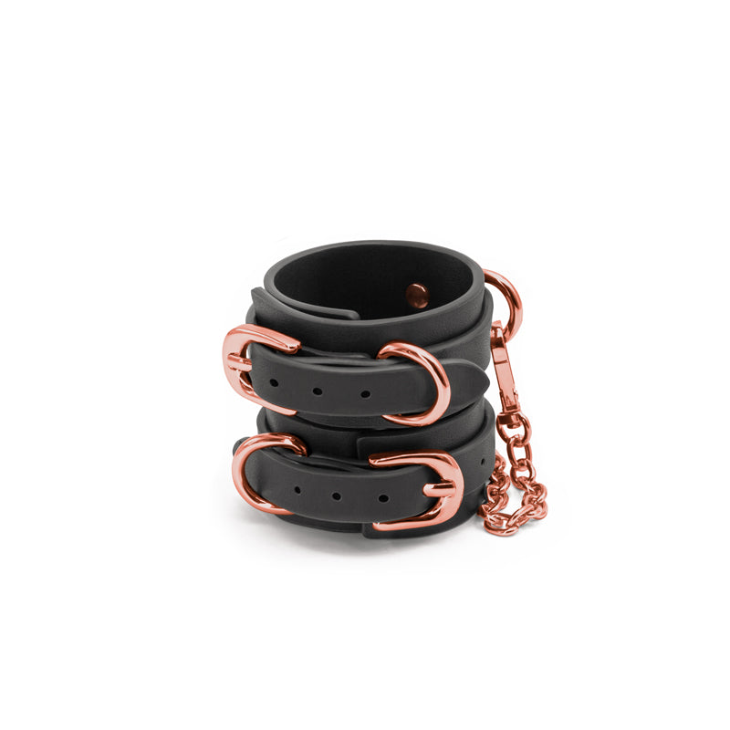Bondage Couture Wrist Cuffs -  -  Restraints featuring black synthetic material and rose gold hardware.