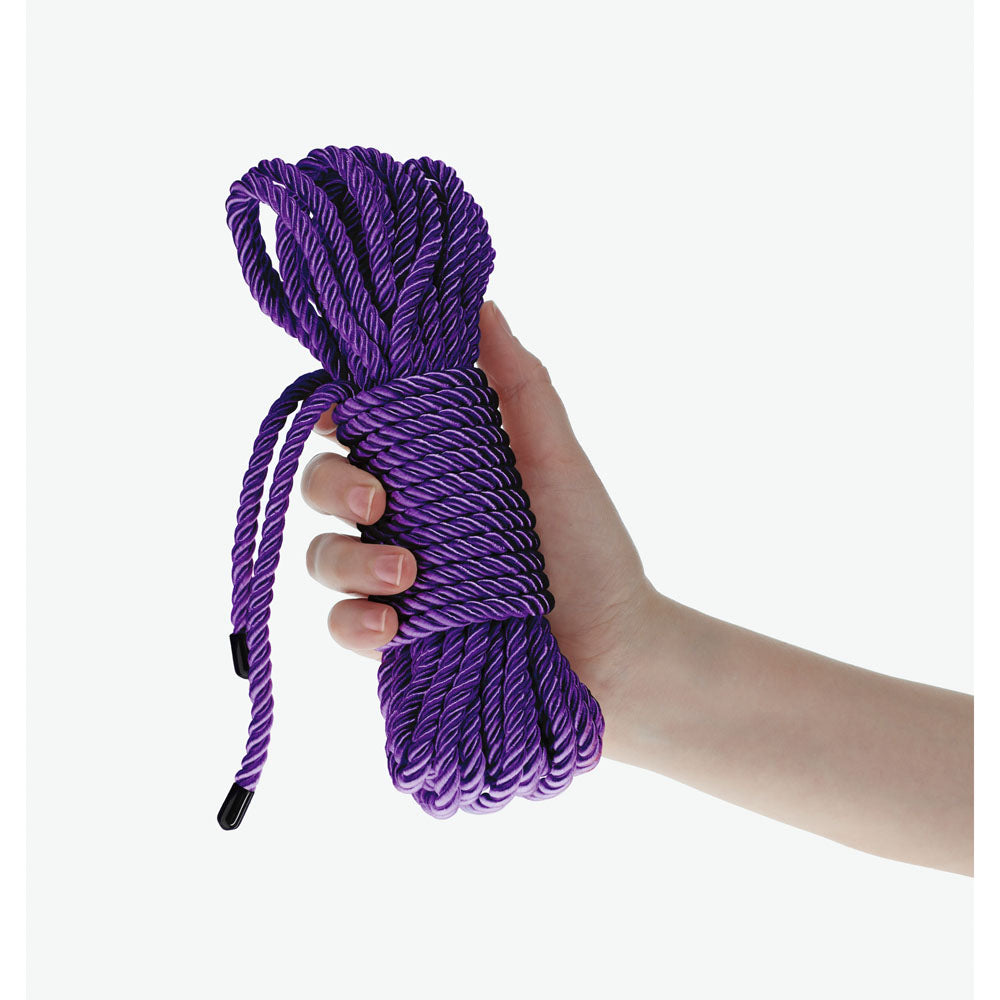 OUCH! Bondage Rope - 10 M -  -  Nylon Bondage Rope - 10 metre Length in a hand, showcasing its strong purple design.