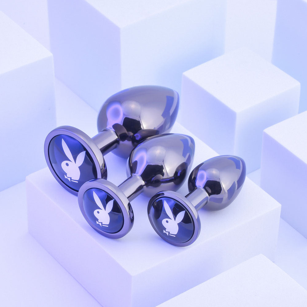 Playboy Pleasure PLEASURE 3 WAYS - Metal Butt Plugs - Set of 3 Sizes displayed against a geometric background.