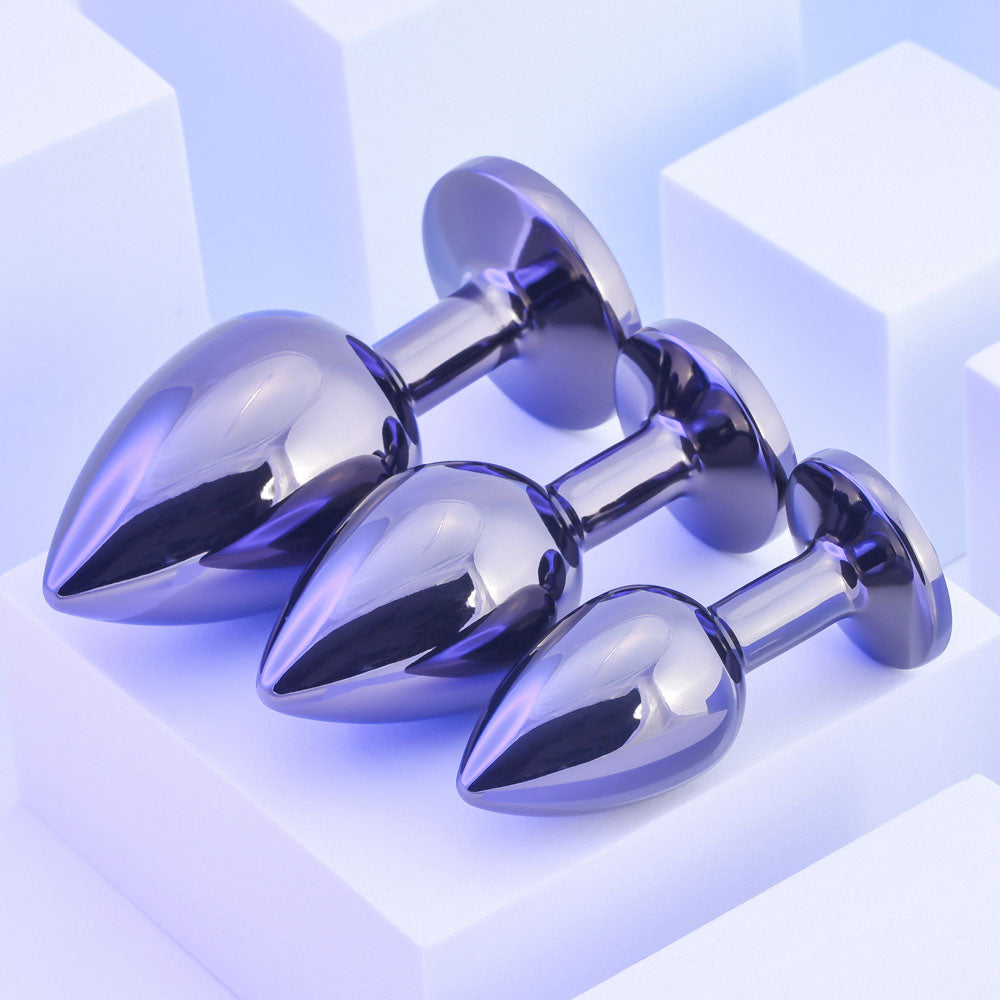 Playboy Pleasure PLEASURE 3 WAYS - Metal Butt Plugs - Set of 3 Sizes displayed on a soft blue background.