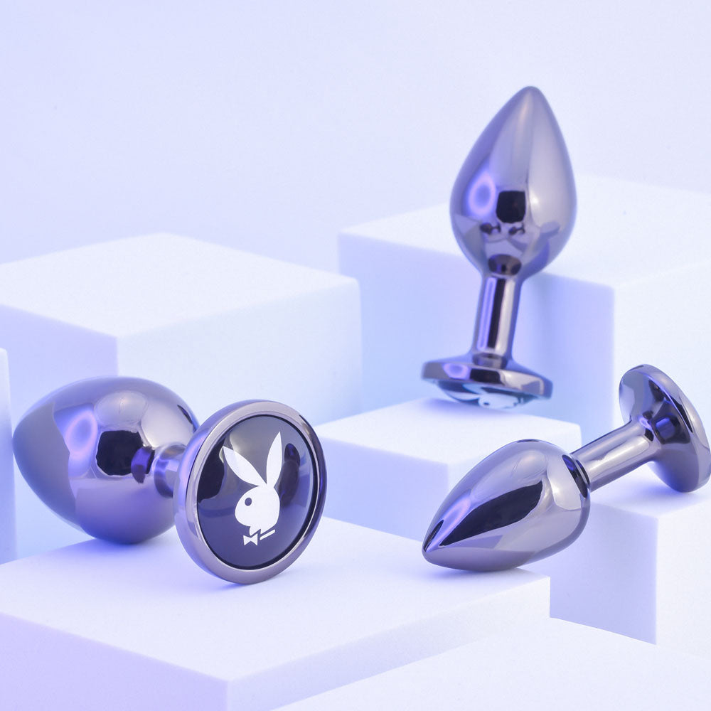 Playboy Pleasure PLEASURE 3 WAYS - Metal Butt Plugs - Set of 3 Sizes displayed on geometric platforms.