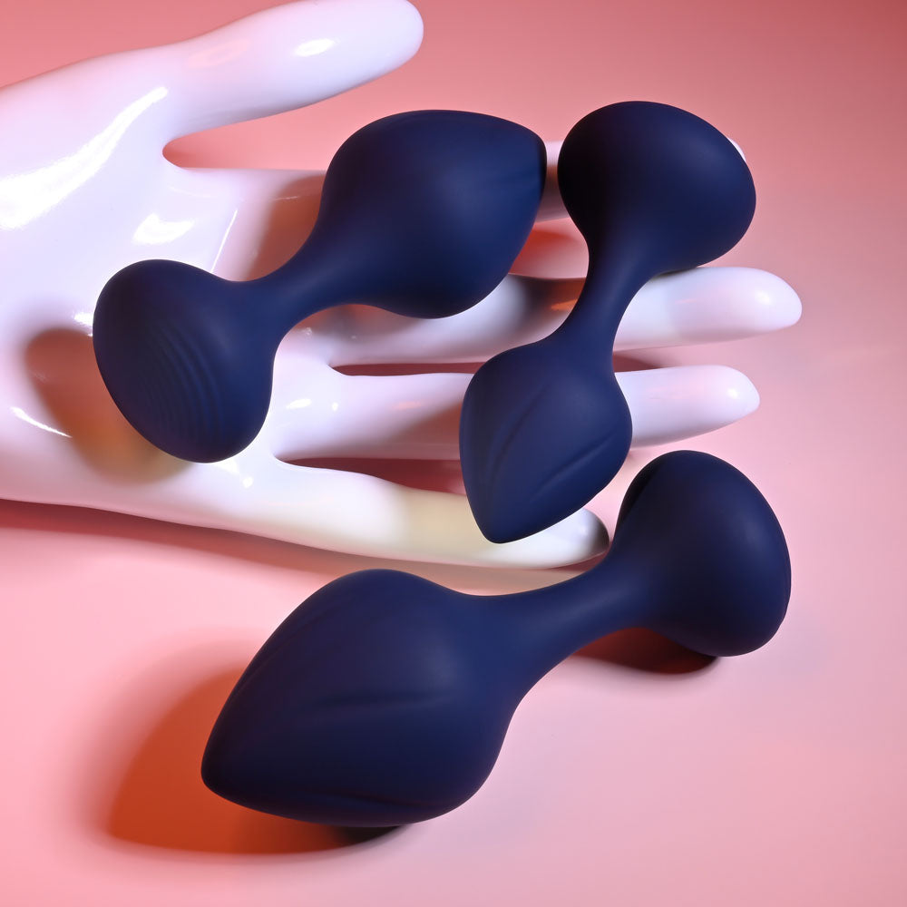Playboy Pleasure TAIL TRAINER - Butt Plugs - Set of 3 Sizes displayed in a hand for safe anal exploration.