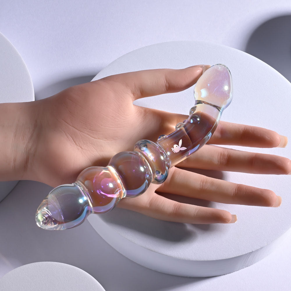 Playboy Pleasure JEWELS DOUBLE -  Glass 17.1 cm Double Ended Dildo shown in a hand, showcasing its elegant design.