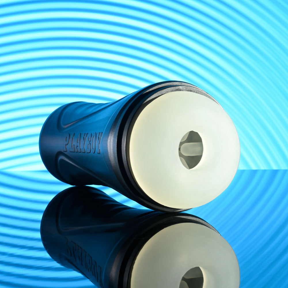 Playboy Pleasure THE URGE MEDIUM - Clear Stroker on reflective surface with blue background.