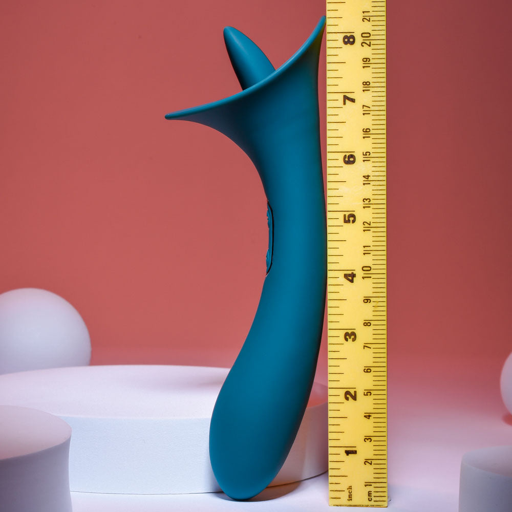 Playboy Pleasure TRUE INDULGENCE - Teal 21.3 cm USB Rechargeable Vibrator with Flicking Tip next to a ruler for size reference.